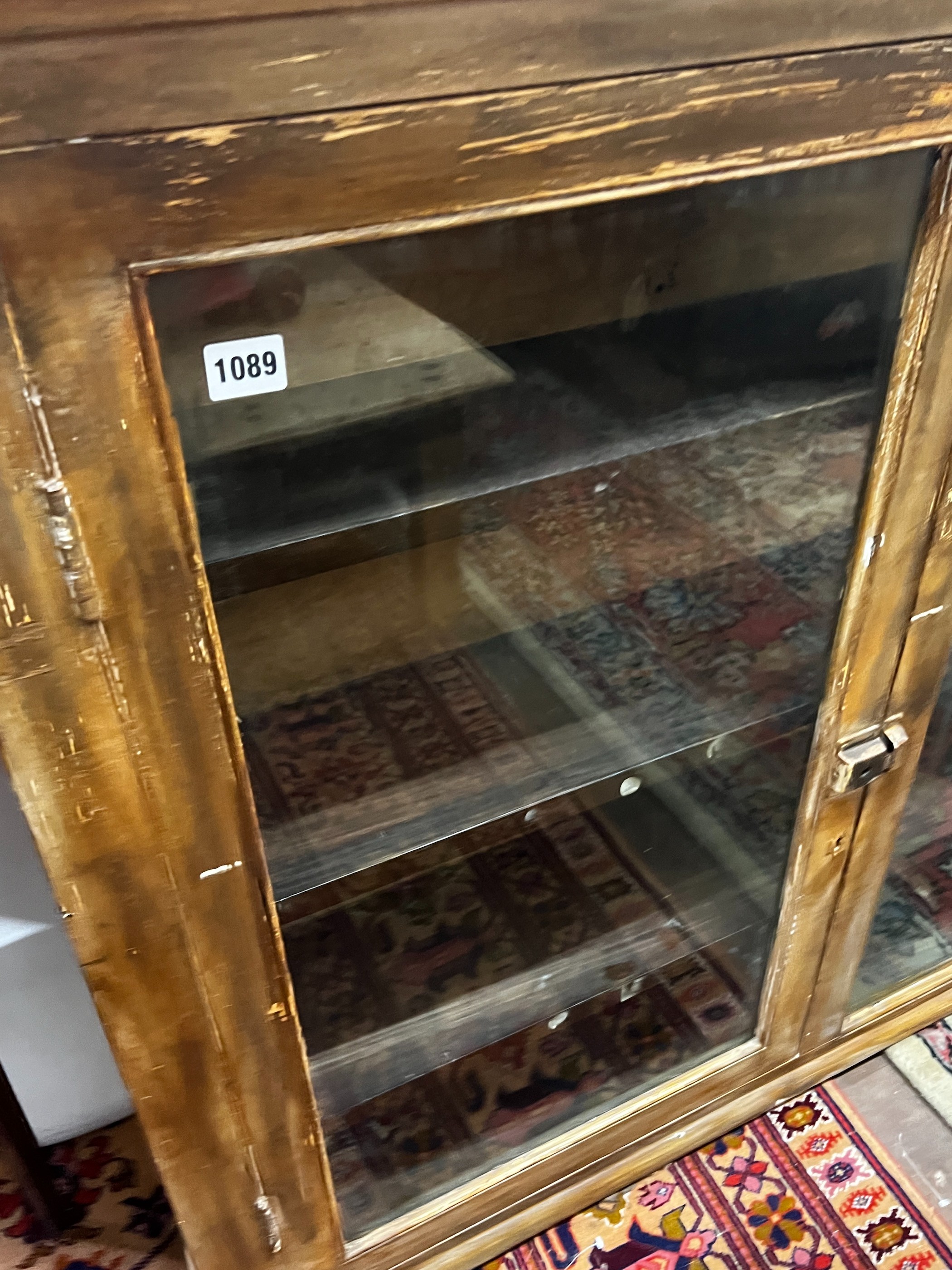 A late 19th / early 20th century painted glazed three door hanging cabinet, width 158cm, depth 22cm, height 96cm